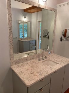 bathroom countertop with mirror on the wall