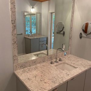 bathroom countertop with mirror on the wall