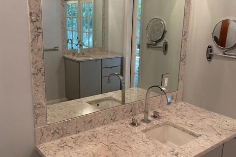 bathroom countertop with mirror on the wall