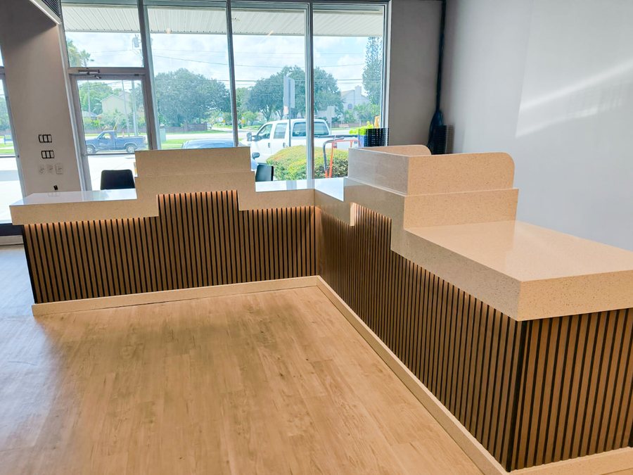 custom quartz reception desk with fluted wood front melbourne fl