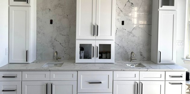 vanity with full height stone backsplash melbourne fl